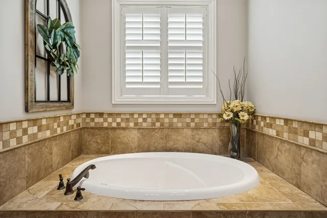 a bath tub sitting in a bathroom next to a window
