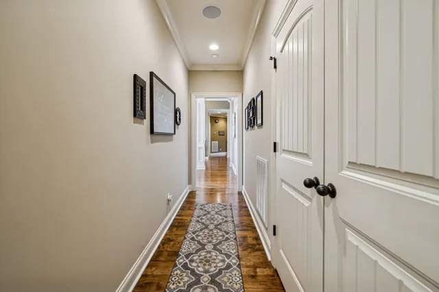a view of a hallway with wooden floor and staircase