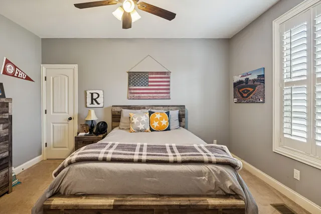 a bedroom with a bed and a chandelier