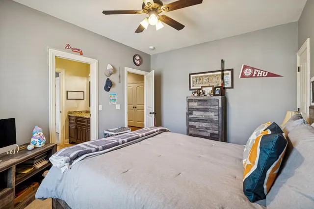 a bedroom with a bed and a chandelier