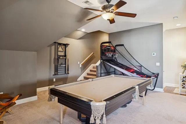 a room with pool table and a chandelier