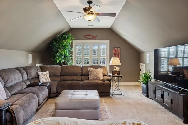 a living room with furniture a chandelier and a window