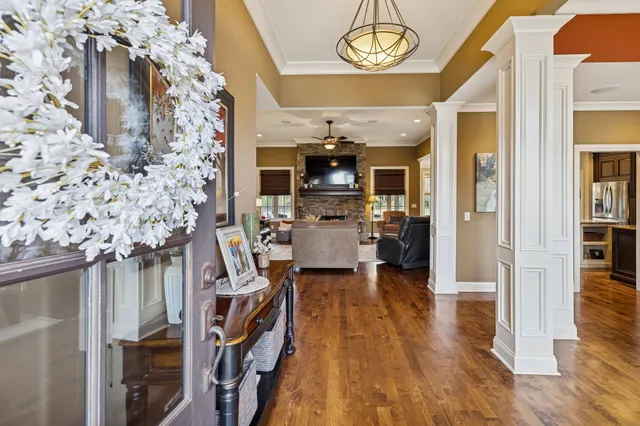 a view of a dining room with furniture wooden floor and a chandelier