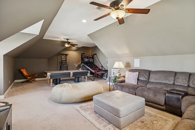a living room with furniture and a chandelier