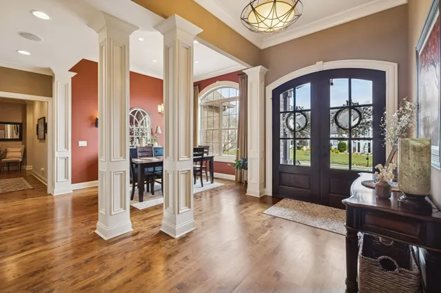 a living room with furniture and a floor to ceiling window