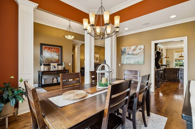 a view of a dining room with furniture wooden floor and chandelier