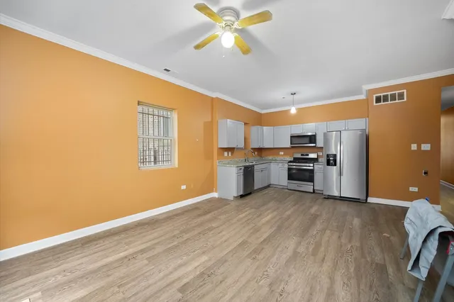 a view of kitchen with wooden floor electronic appliances and window