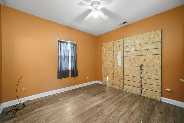 an empty room with wooden floor and closet