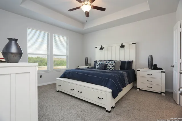 a spacious bedroom with a bed and a window