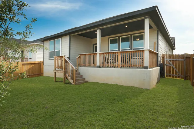 a view of a house with a yard and porch