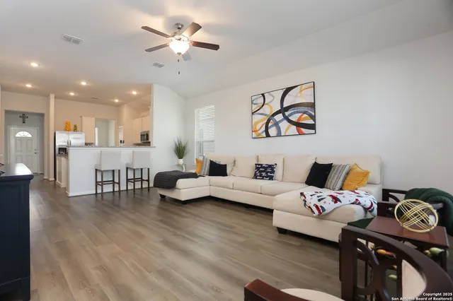 a living room with furniture and kitchen view
