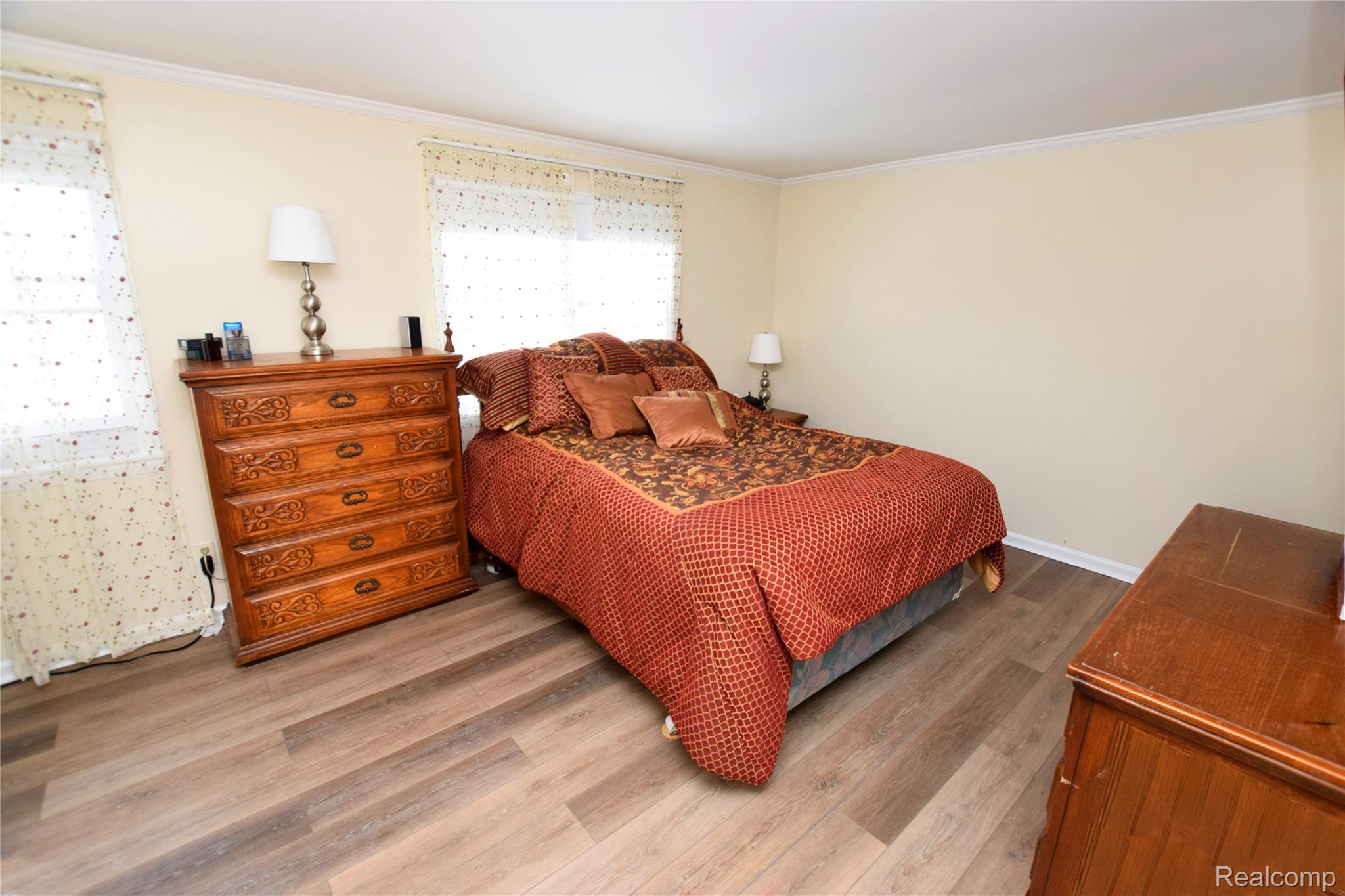 15489 Linden Road Linden, MI 48451 - Photo 13 of 25 Bedroom with wood finished floors and Crown Molding