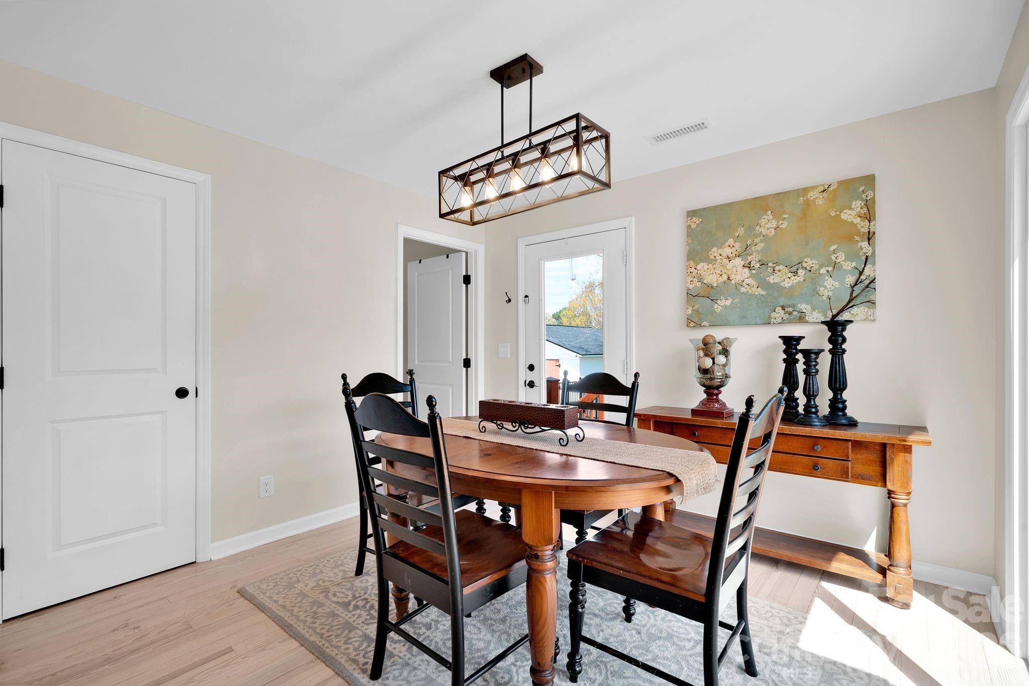 1252 Houston Mill Road Conover, NC 28613 - Photo 15 of 43 a view of a dining room with furniture and wooden floor