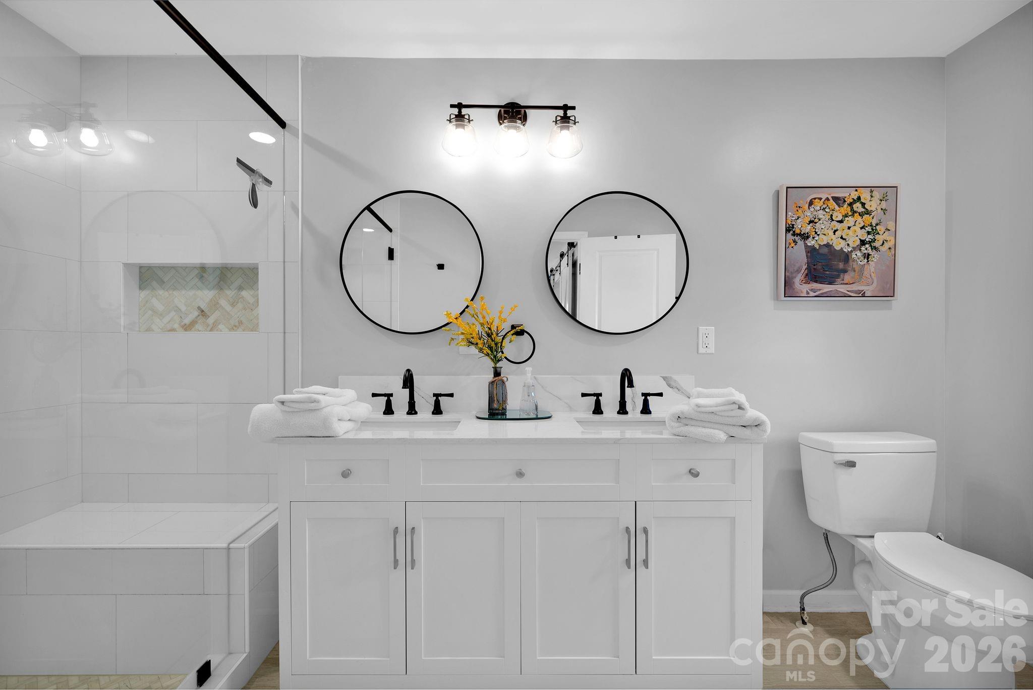 1252 Houston Mill Road Conover, NC 28613 - Photo 20 of 43 a bathroom with a toilet a sink and a mirror