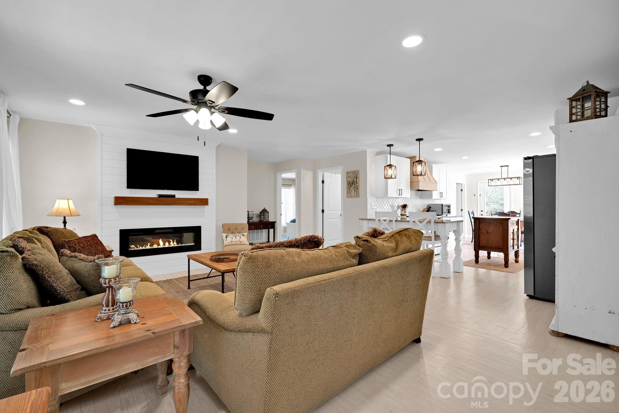 1252 Houston Mill Road Conover, NC 28613 - Photo 7 of 43 a living room with furniture a fireplace and a flat screen tv