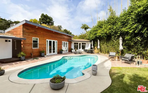 a swimming pool with outdoor seating and yard