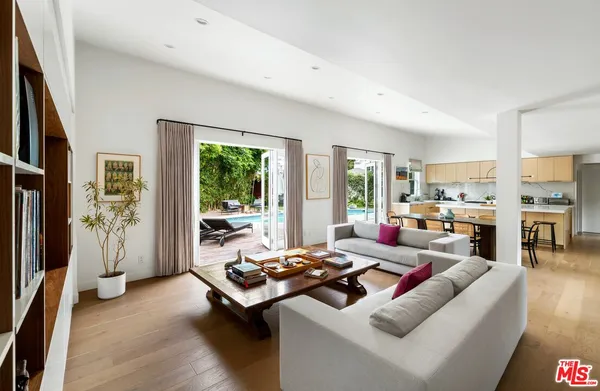 a living room with furniture fireplace and large windows