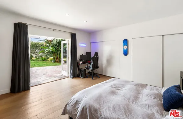 a bed room with a bed and a large window