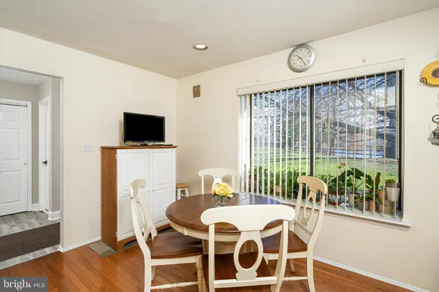 a dining room with furniture and wooden floor