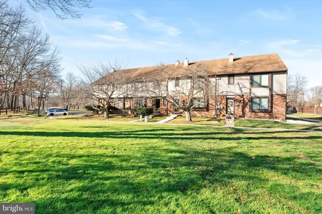 a front view of a building with a garden