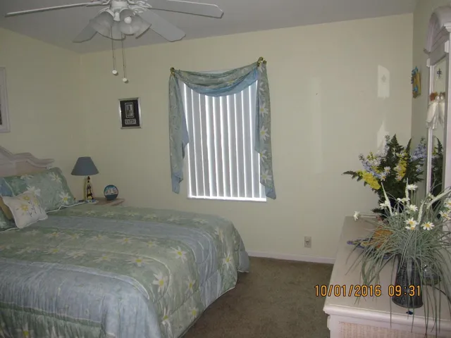 a bedroom with a bed and a potted plant