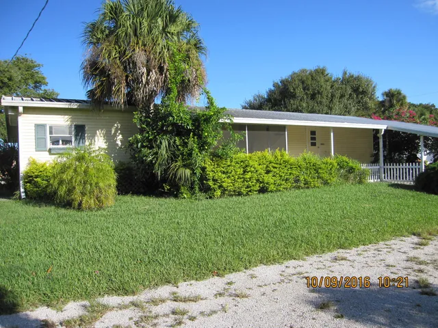a kitchen with a refrigerator and table