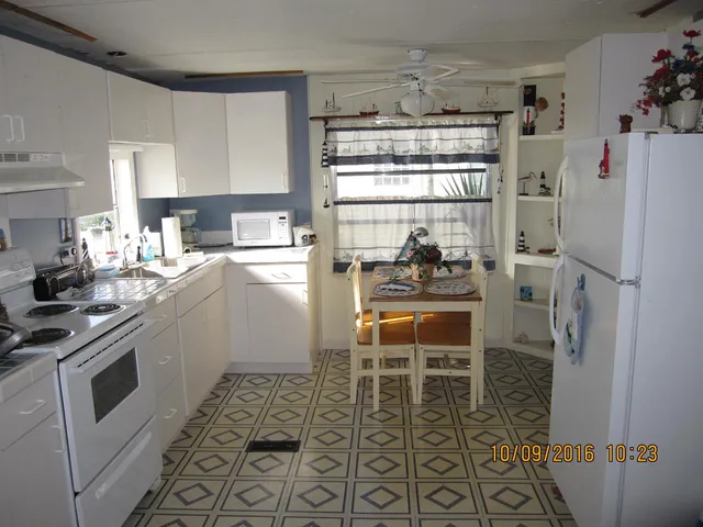 a living room with furniture a chandelier and a dining table