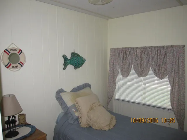 a view of a house with a yard and a garden