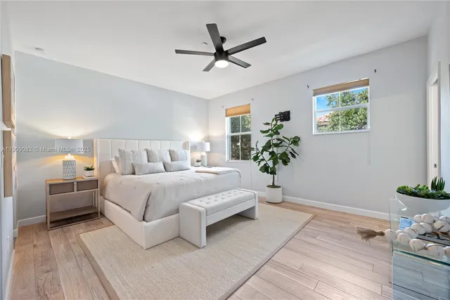 a bedroom with a bed and a potted plant