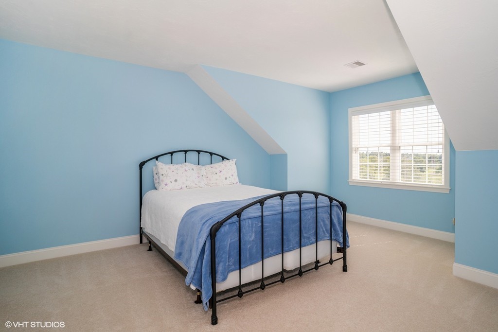 68 Brookside Road, Unit 199 Bourne, MA 02532 - Photo 12 of 15 a bed sitting in a bedroom next to a window