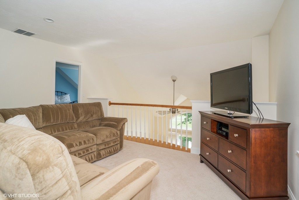 68 Brookside Road, Unit 199 Bourne, MA 02532 - Photo 8 of 15 a living room with furniture and a flat screen tv