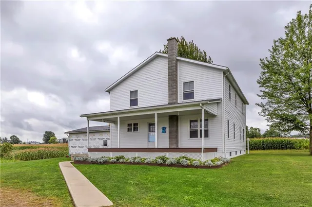 a front view of a house with a garden