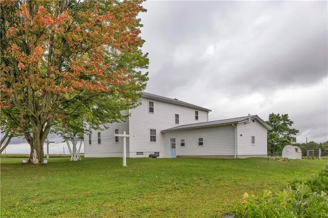 a view of a couches in front of house with a big yard