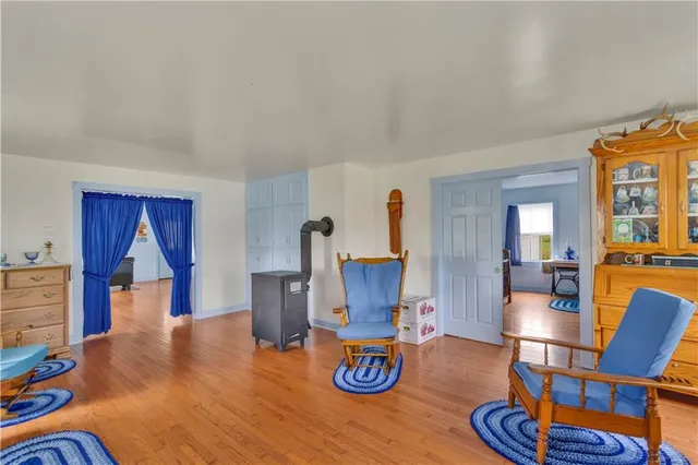 a living room with furniture and wooden floors