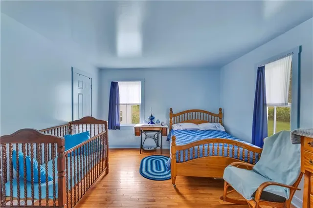 a bedroom with furniture and wooden floor
