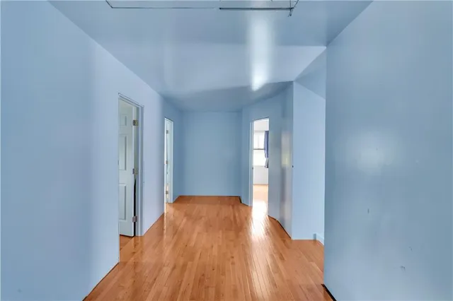 a view of a room with wooden floor