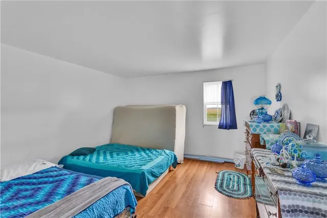 a bedroom with two beds and potted plant