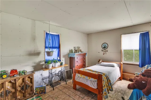 a bed room with bed and a window