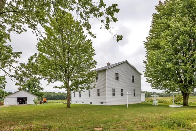 a view of a white house with a yard