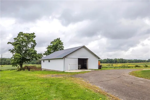 a view of a house with a yard and lake view