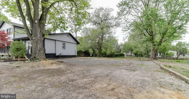 a view of a house with a tree and a yard