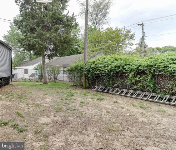 a view of a house with a tree in the yard
