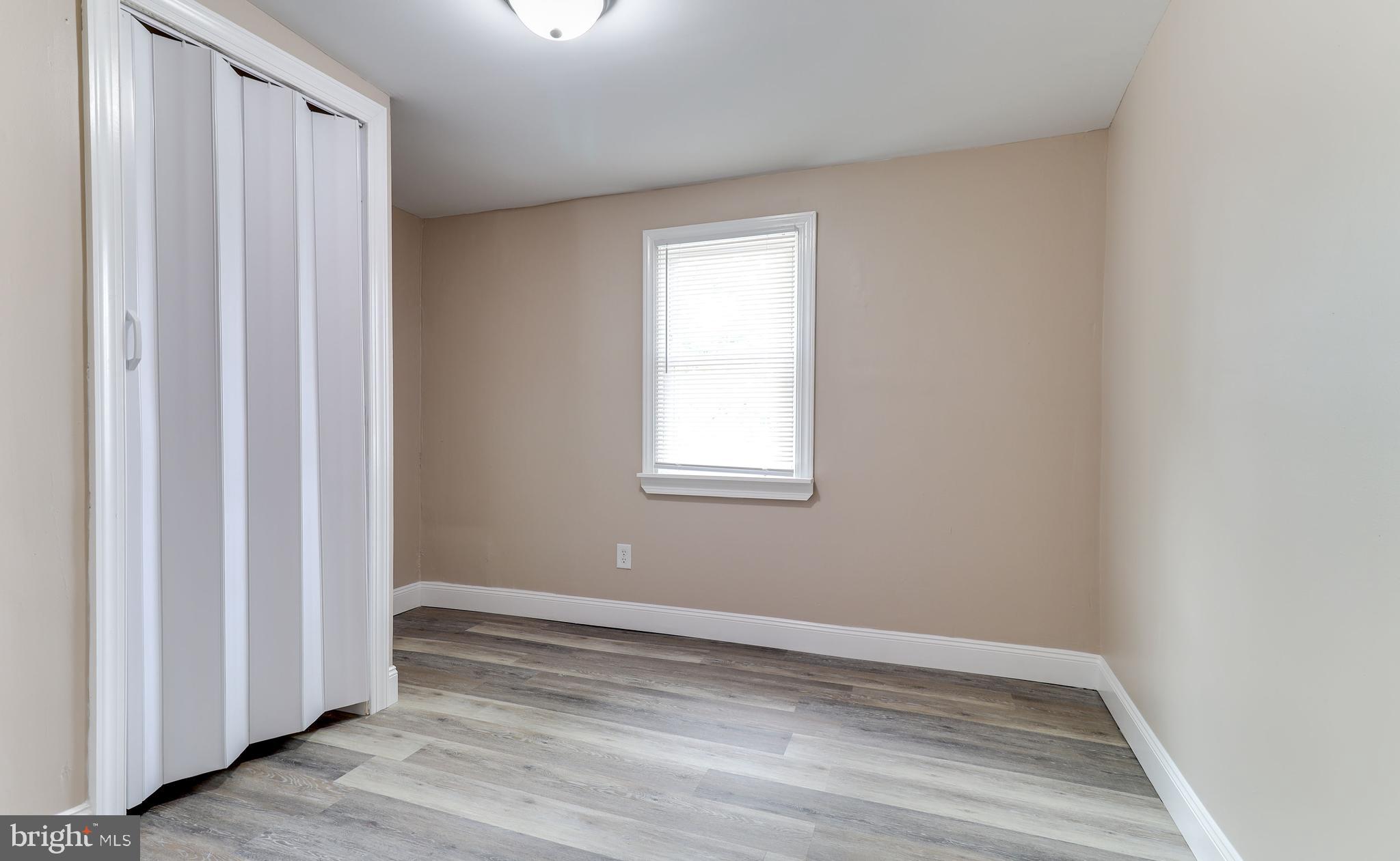 204 West Landing Road Mantua, NJ 08051 - Photo 8 of 20 a view of an empty room with wooden floor and a window