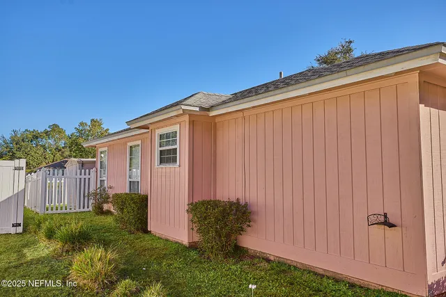 a view of a small house with backyard