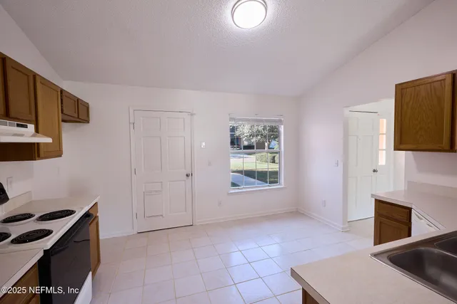 a view of a kitchen with an oven cabinets and a window