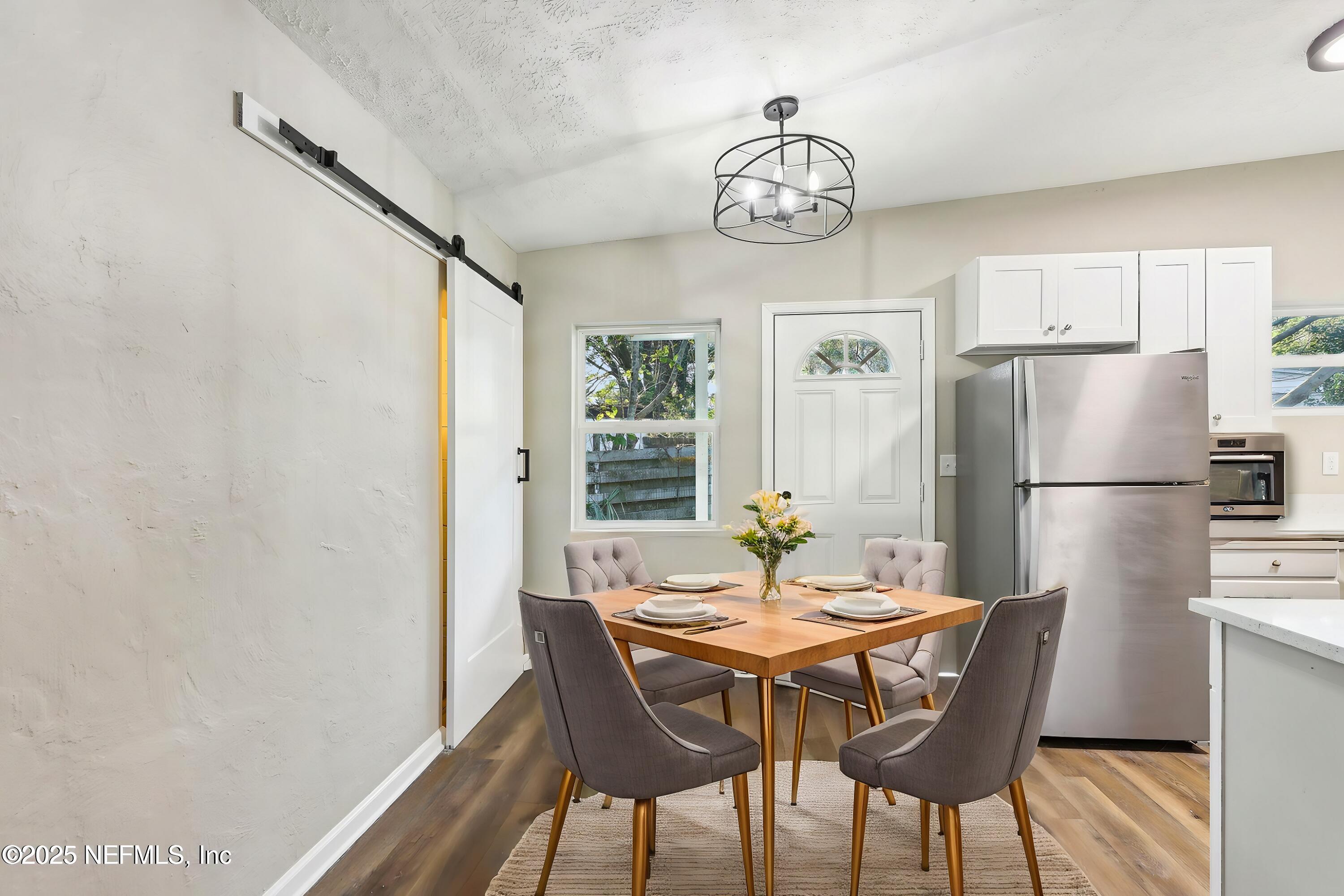 1268 King Arthur Road Jacksonville, FL 32211 - Photo 15 of 35 a view of a dining room with furniture a chandelier and wooden floor