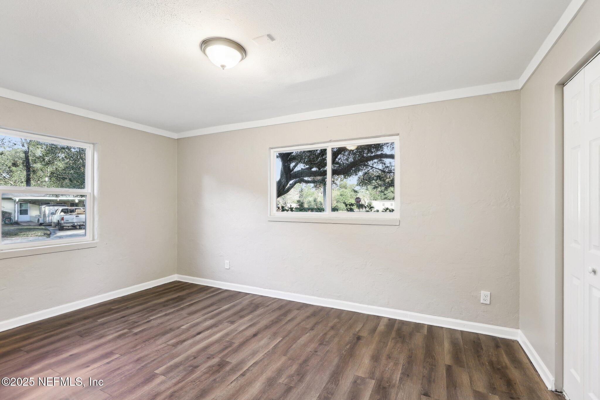 1268 King Arthur Road Jacksonville, FL 32211 - Photo 23 of 35 a view of an empty room with wooden floor and a window