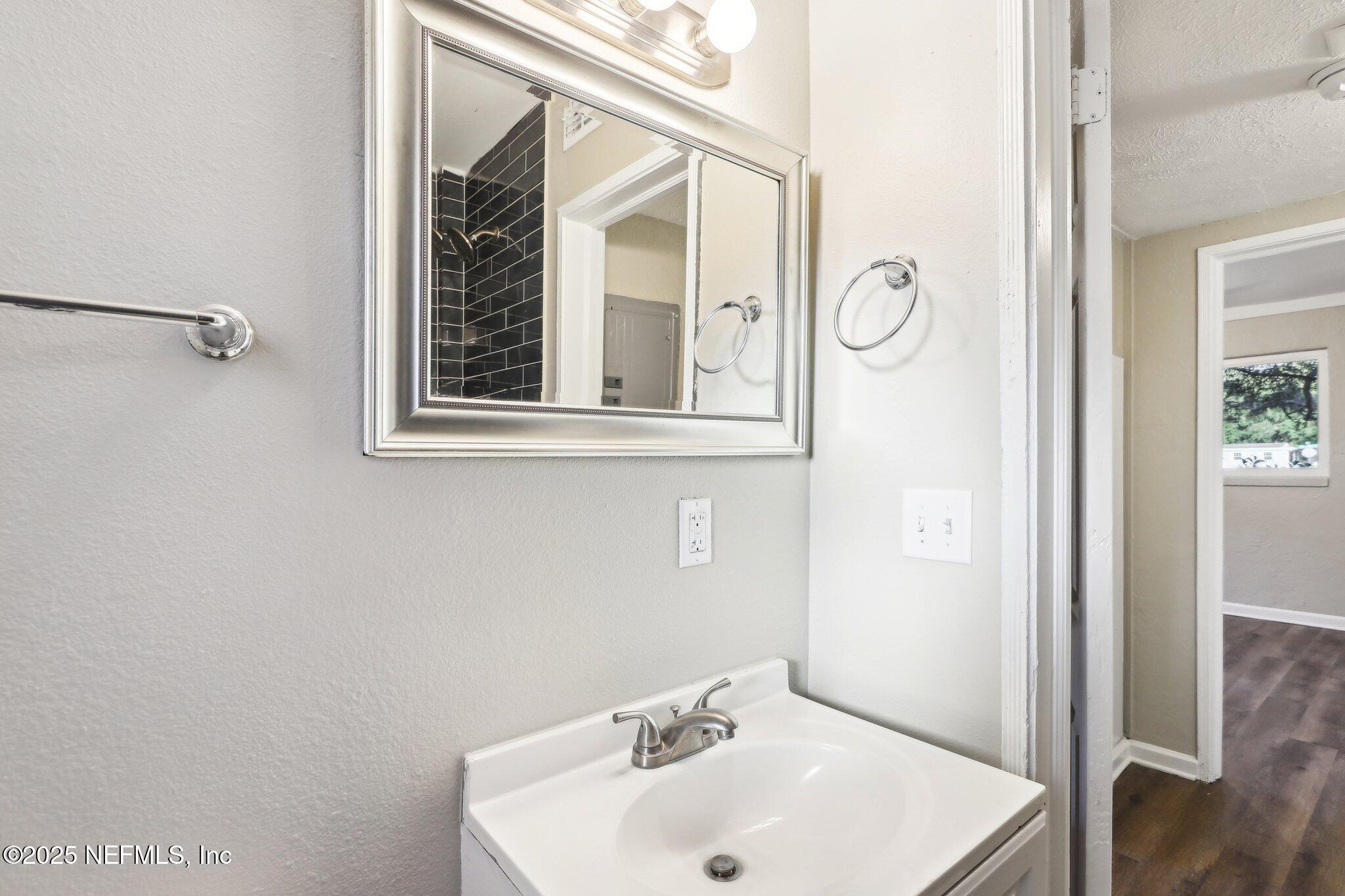 1268 King Arthur Road Jacksonville, FL 32211 - Photo 25 of 35 a bathroom with a sink and a mirror