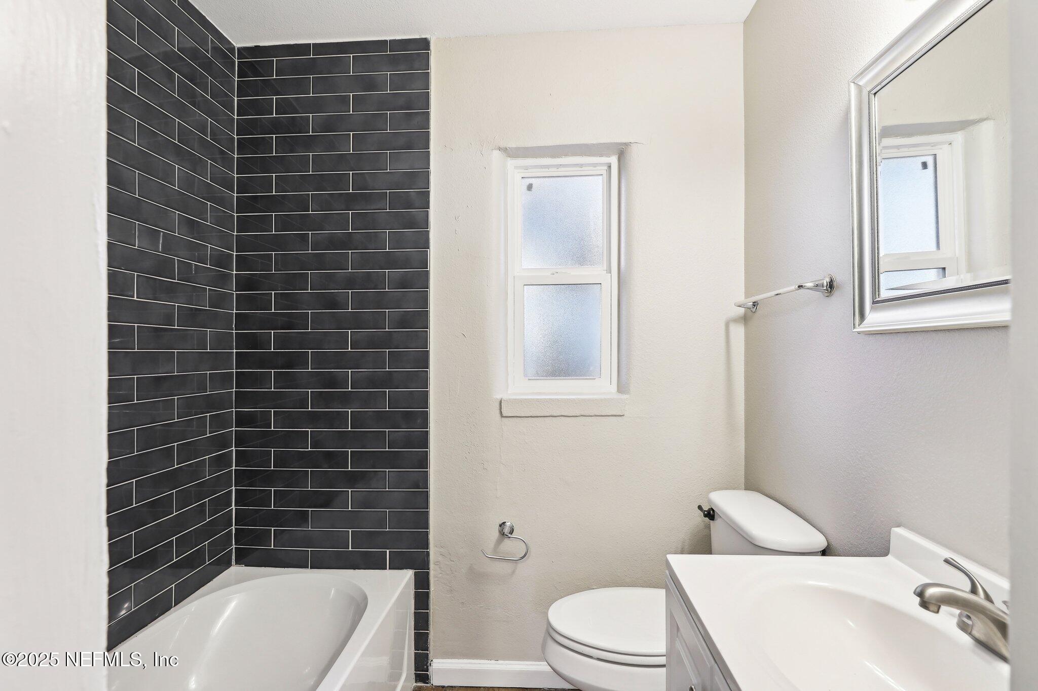 1268 King Arthur Road Jacksonville, FL 32211 - Photo 26 of 35 a bathroom with a toilet a sink and bathtub