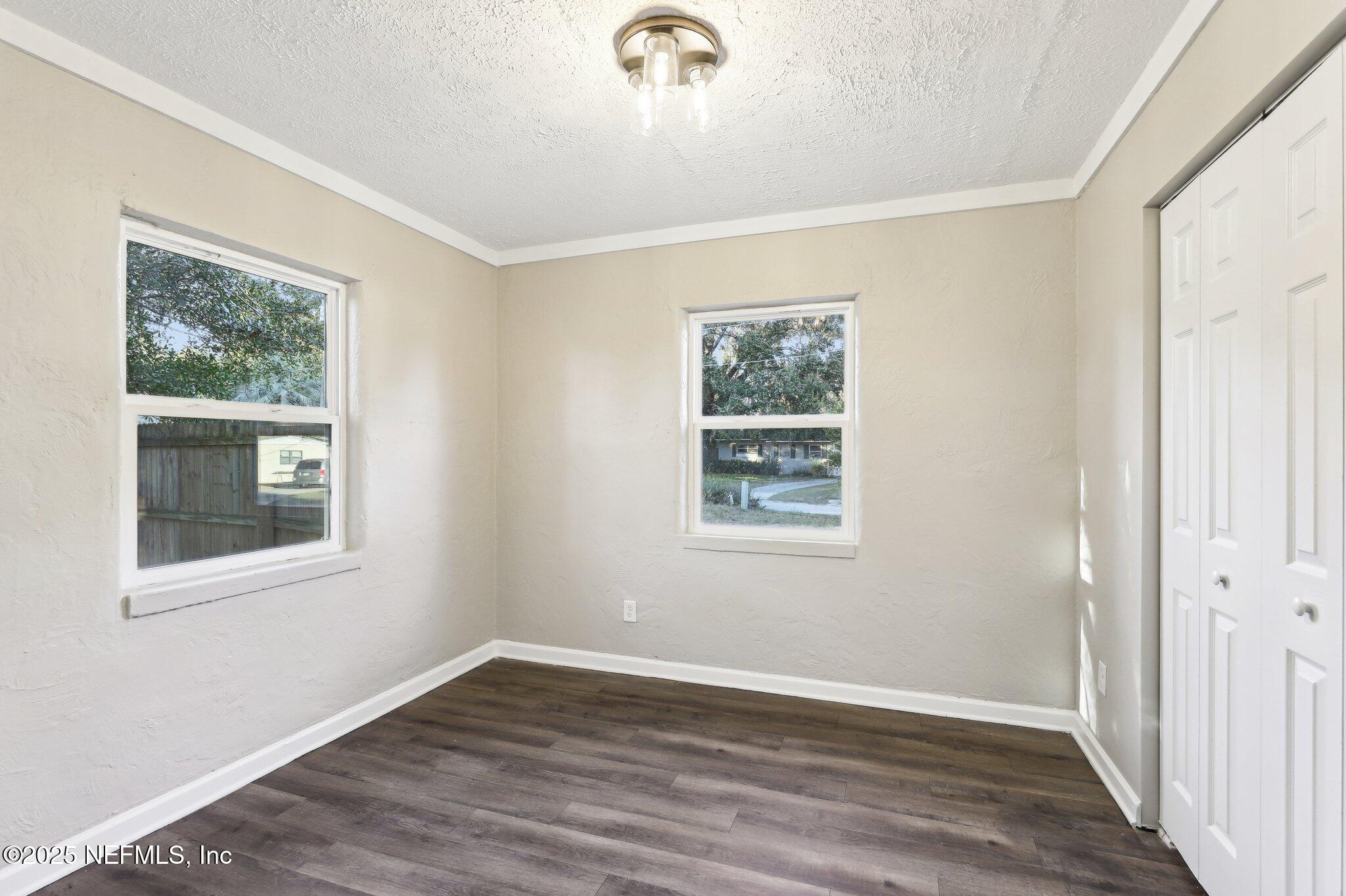 1268 King Arthur Road Jacksonville, FL 32211 - Photo 28 of 35 a view of an empty room with wooden floor and a window